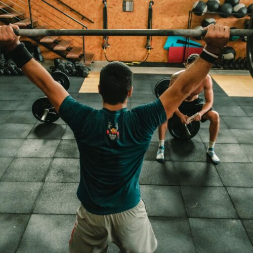 person lifting barbell indoors